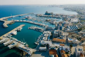 Luxury yachts docked at Limassol Marina with modern buildings and blue sky