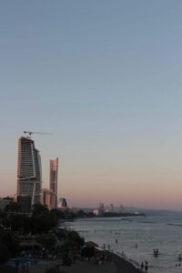 Coastal view of Limassol city with promenade, palm trees, and modern buildings