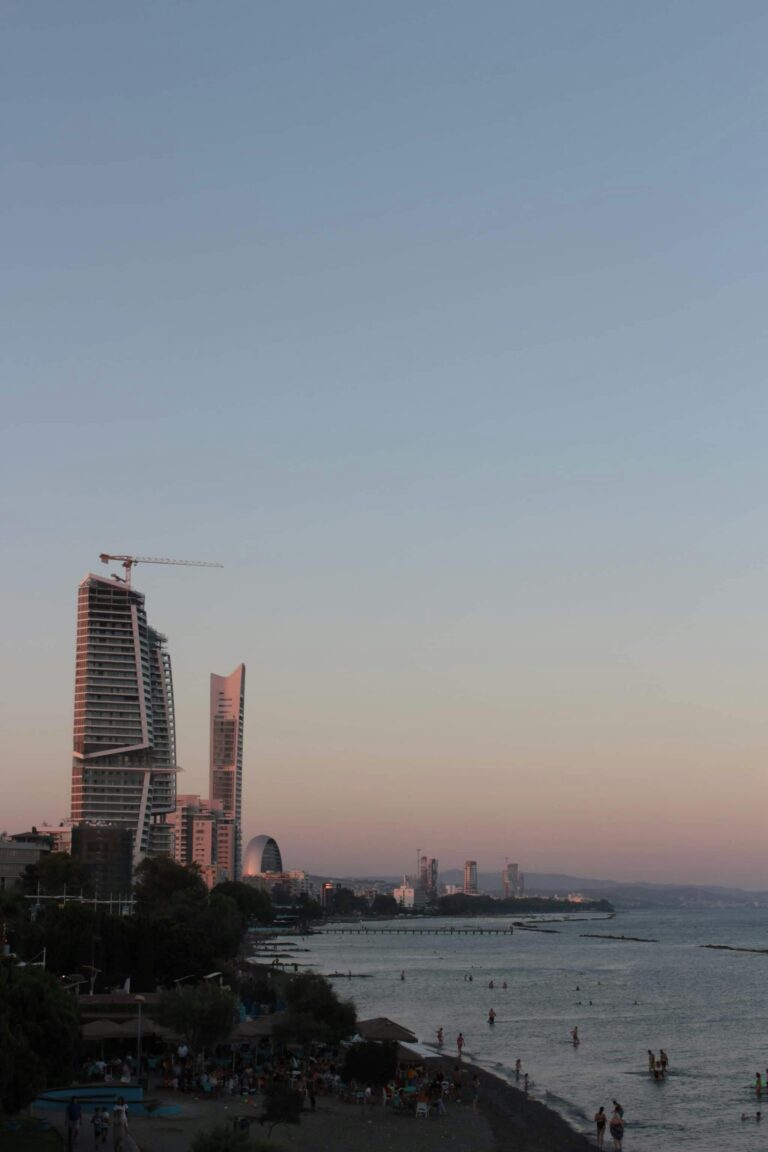 Coastal view of Limassol city with promenade, palm trees, and modern buildings