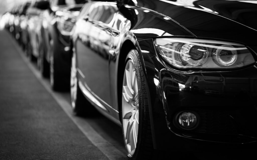 Close-up of a black rental car in Limassol Cyprus with a row of cars behind